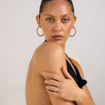 Woman wearing a black dress with a plain background