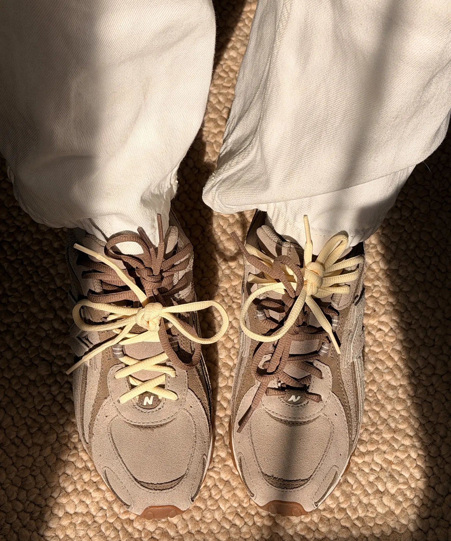 ALI WHITTLE New Balance 204L sneakers with YCL gold charms threaded through the laces