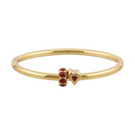 Gold bracelet with red heart-shaped charms on a white background