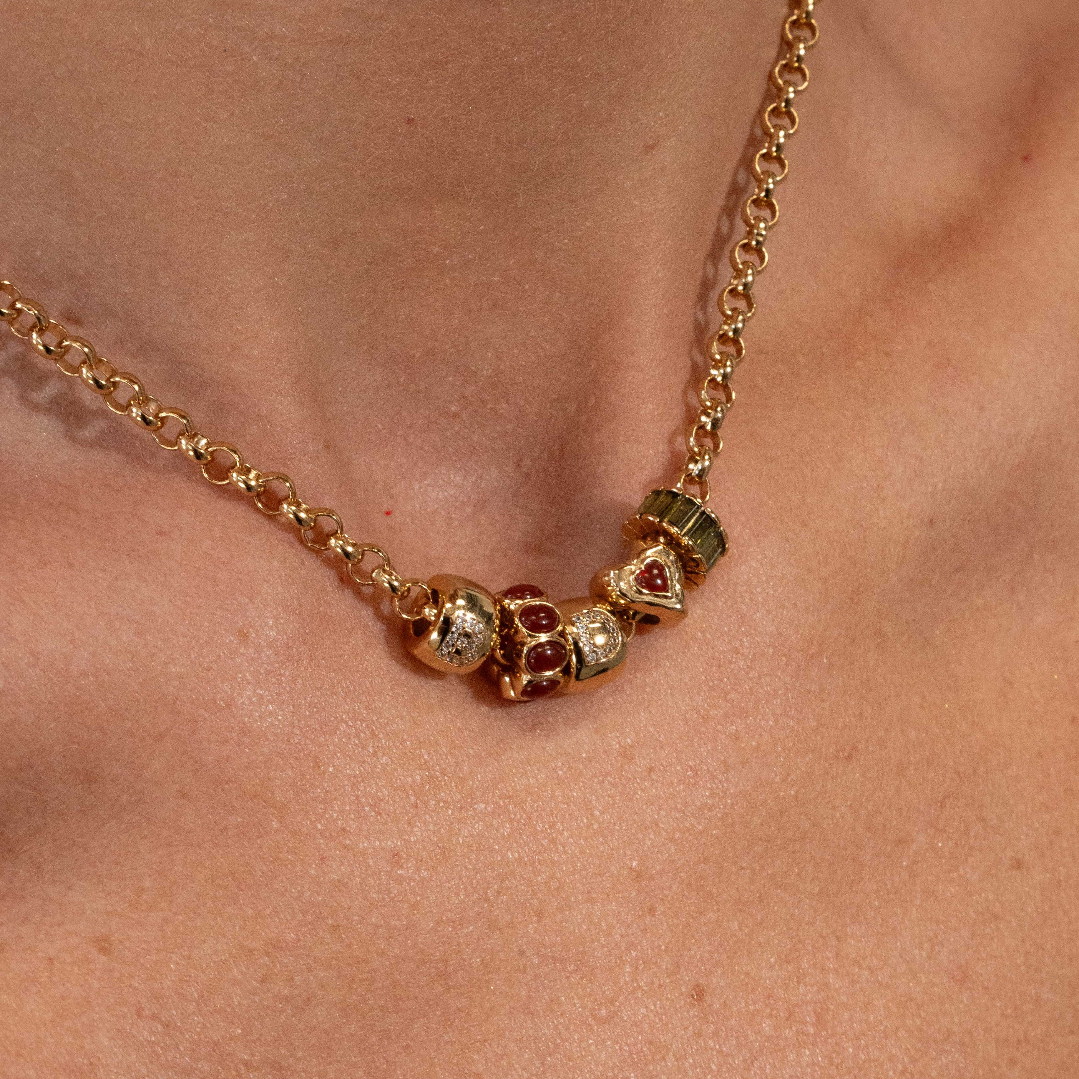 Gold necklace with colorful beads on a person's neck