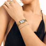 Woman wearing Fine Initial Bracelet and a watch 