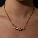 Gold Belcher necklace with beads on a person's neck against a black background