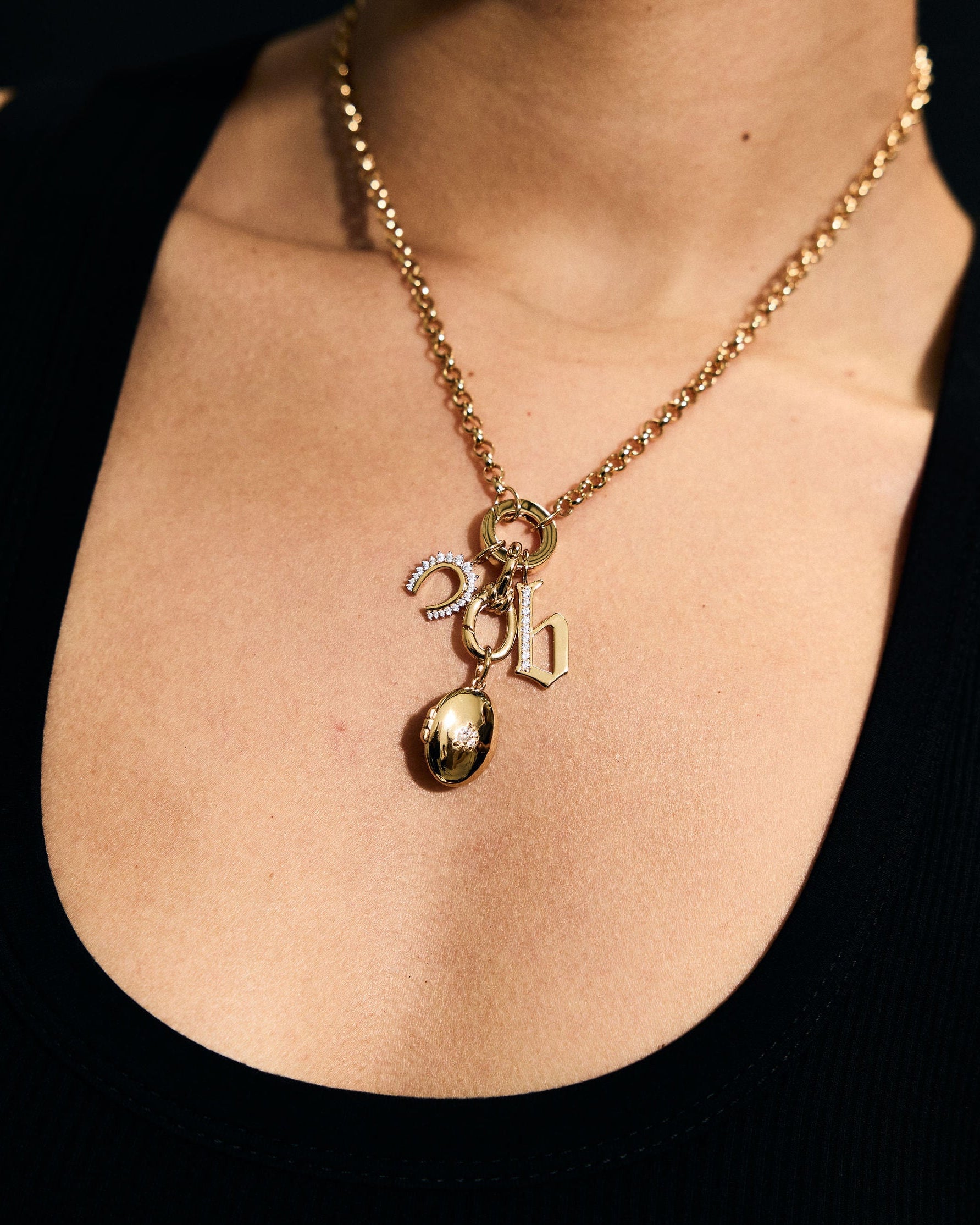 Gold necklace with a gold locket pendant on a person's neck 