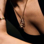 Close-up of a person wearing a chunky gold necklace 