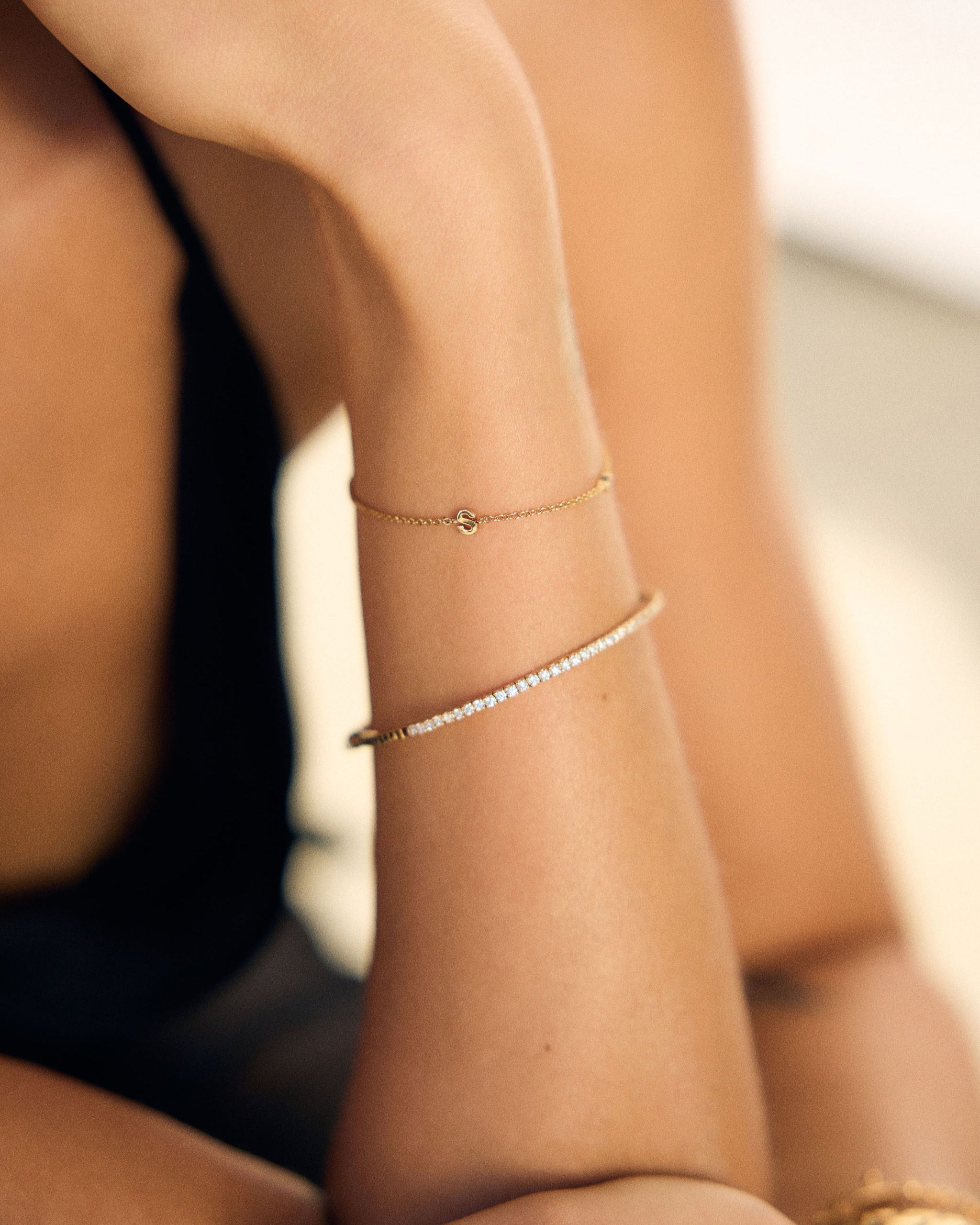 Close-up of a person's arm with gold stacked bracelets