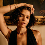 Woman with a deep neckline top in front of a classical painting