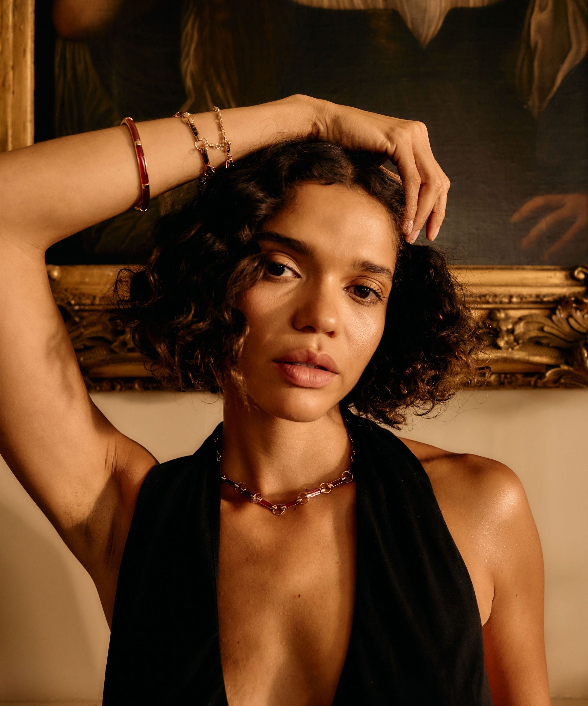 Woman with a deep neckline top in front of a classical painting