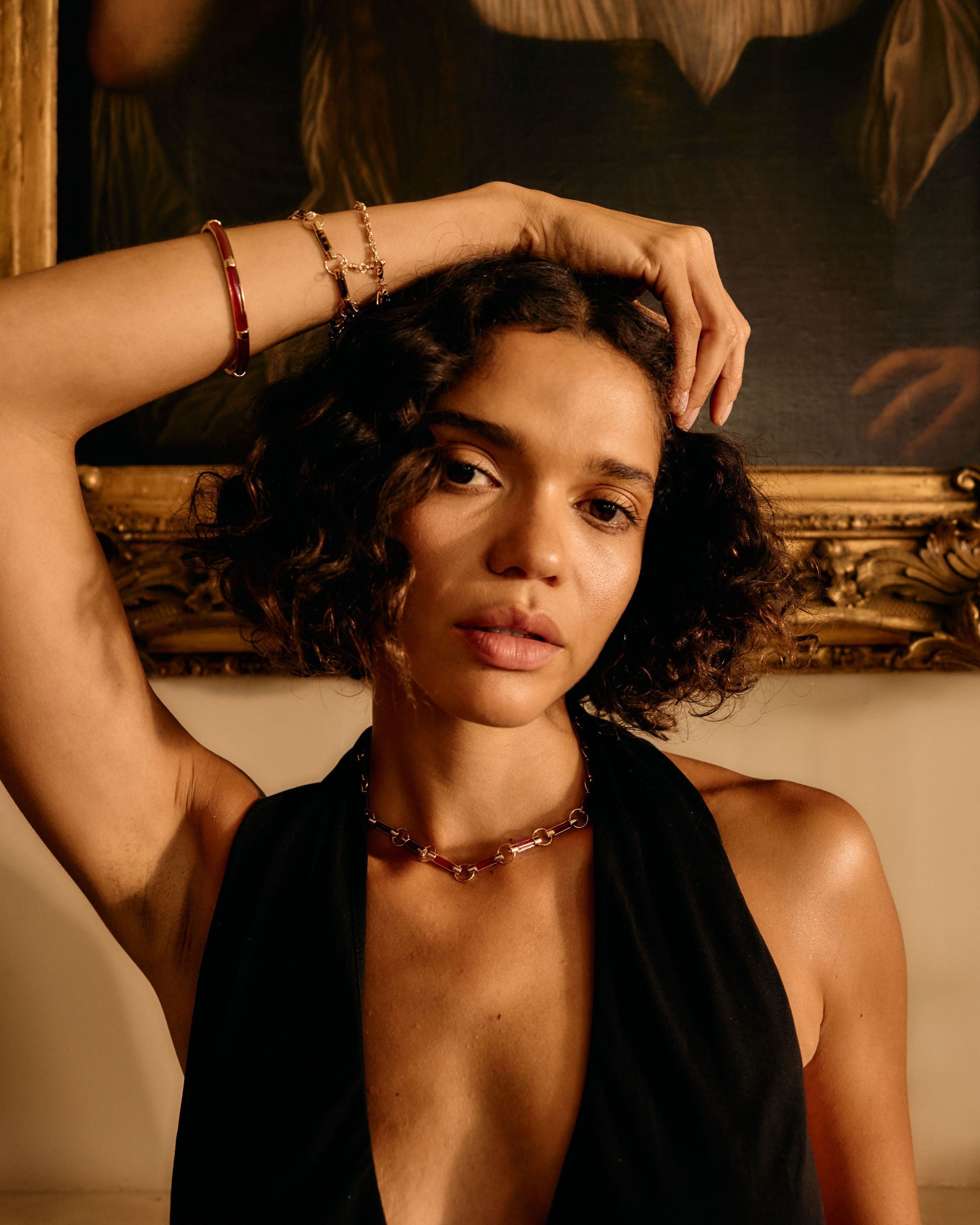 Woman with a deep neckline top in front of a classical painting