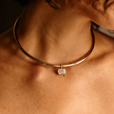 Necklace with a diamond pendant on a person's neck