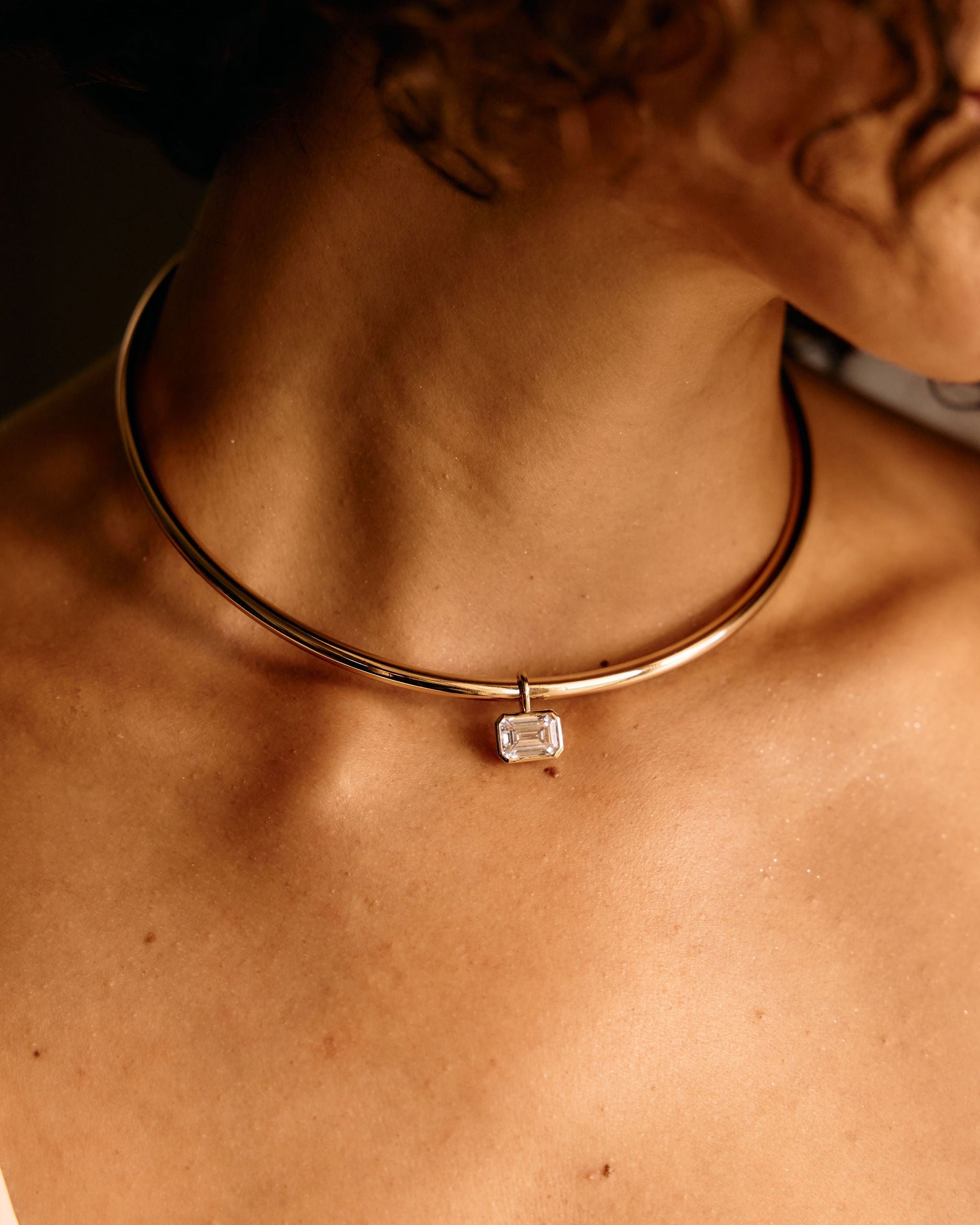Necklace with a diamond pendant on a person's neck
