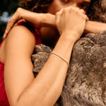 Woman in a red top embracing a stone sculpture