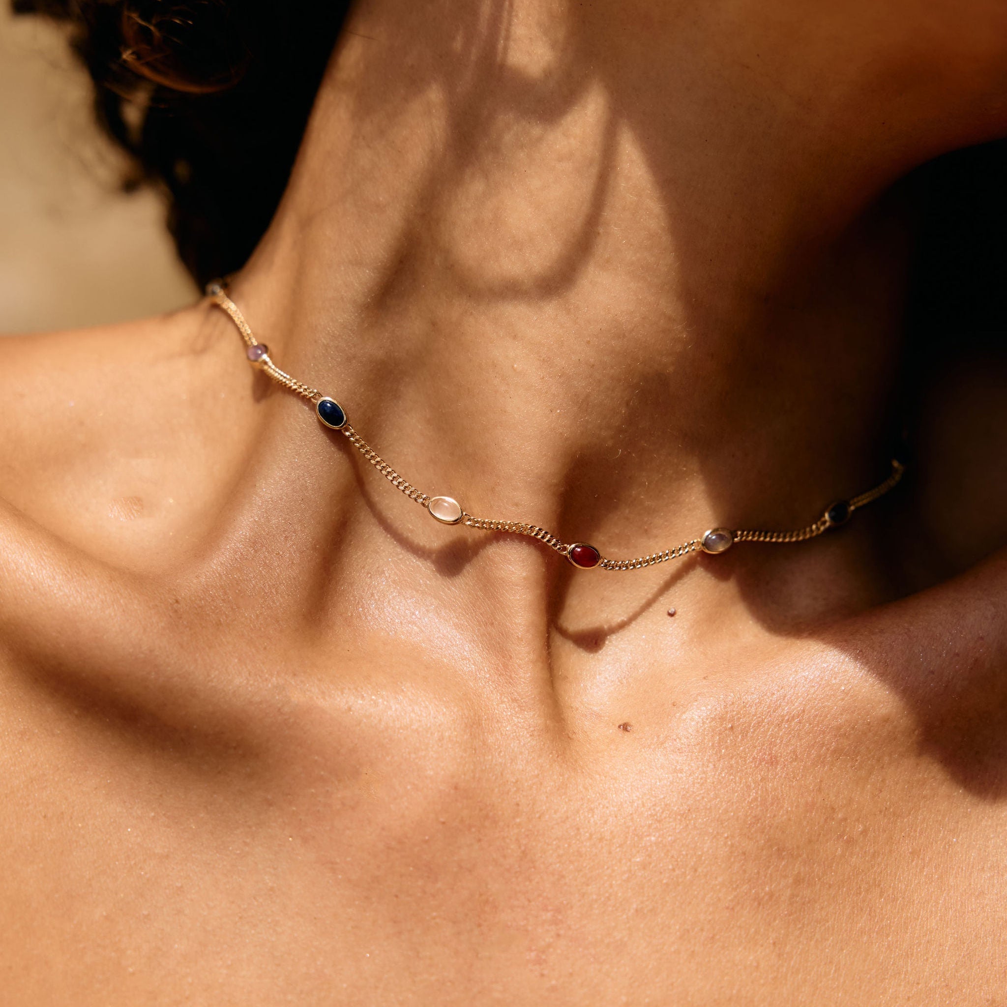 Necklace with small stones on a person's neck