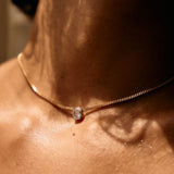 Necklace with a pendant on a person's neck