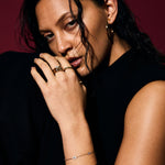 Woman with jewelry against a dark background