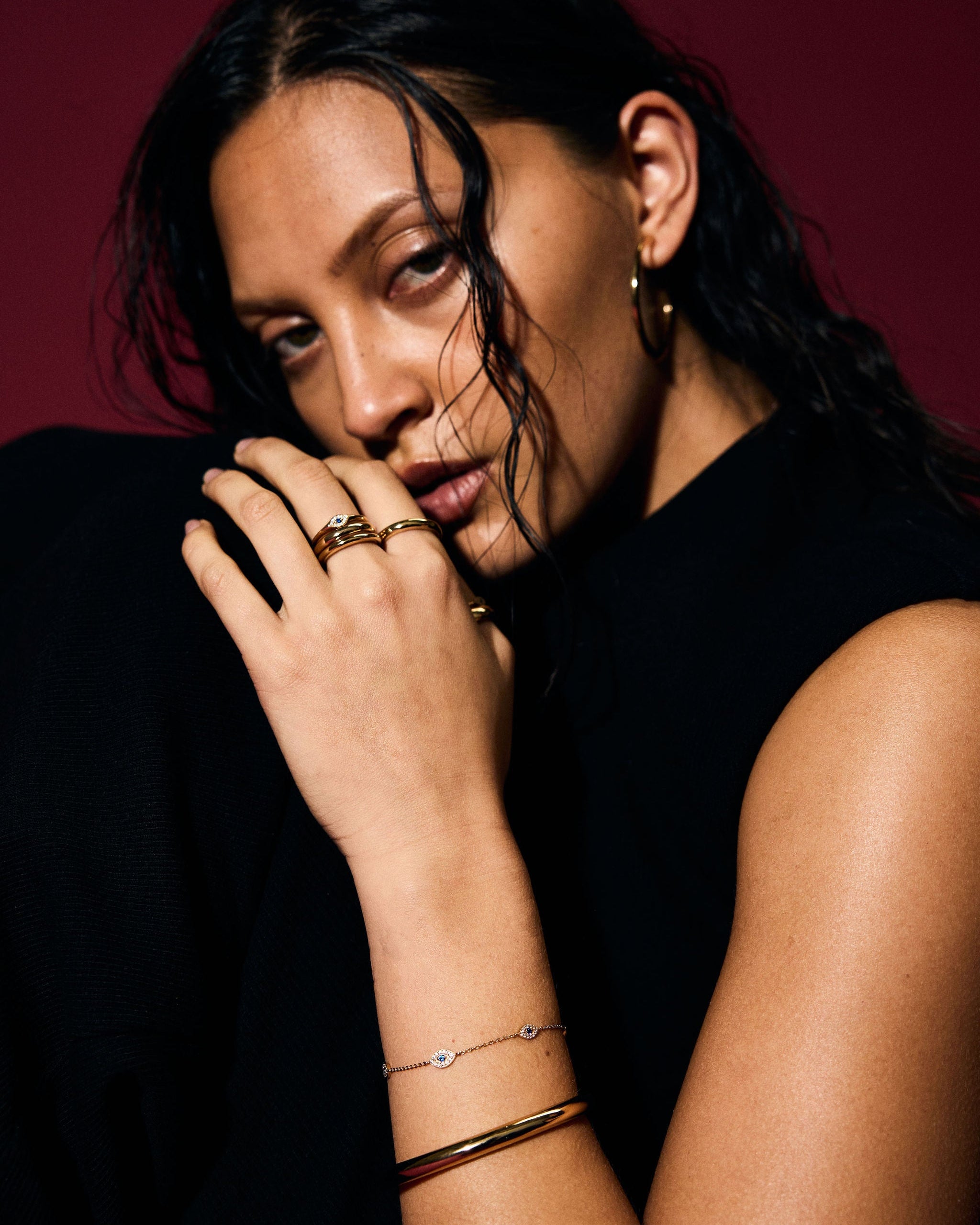 Woman with jewelry against a dark background