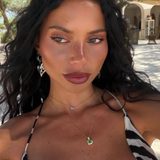 Woman with dark hair and a black and white striped top outdoors