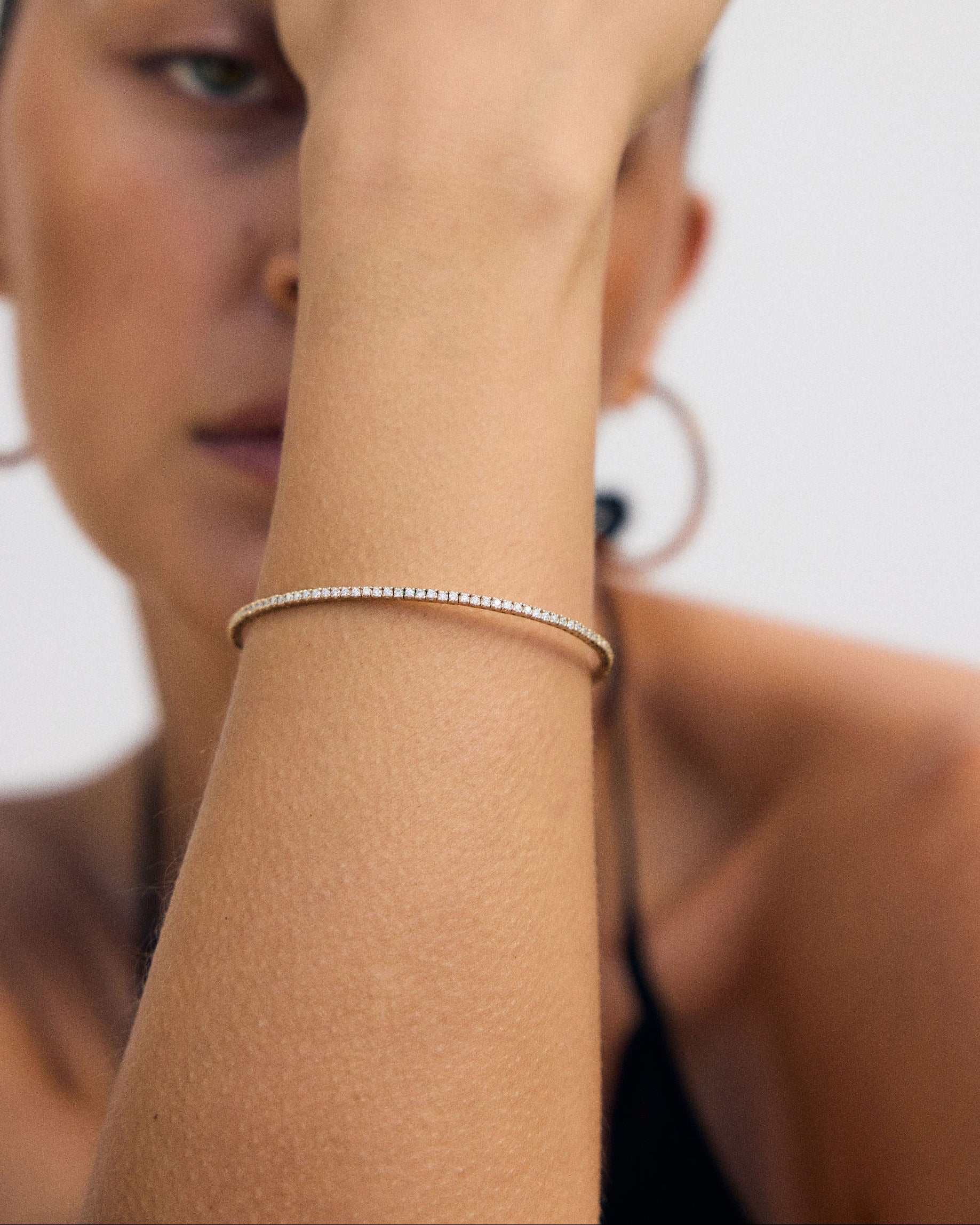 Woman wearing a Diamond Tennis Bangle on a white background