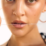 Close-up of a woman's face with a Sterling silver letter bracelet
