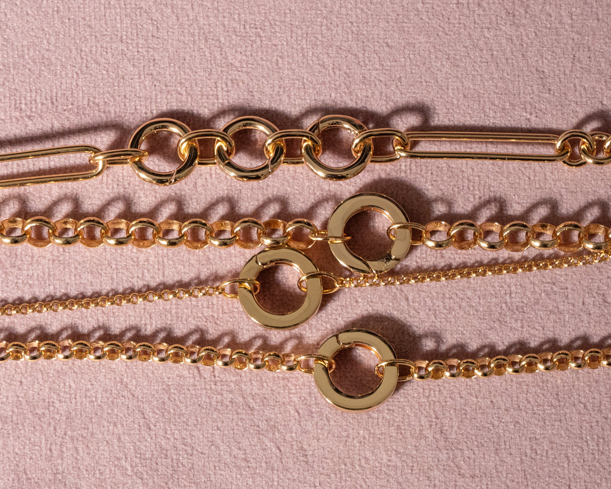 Gold chains on a pink background