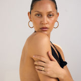 Woman wearing a black dress with a plain background