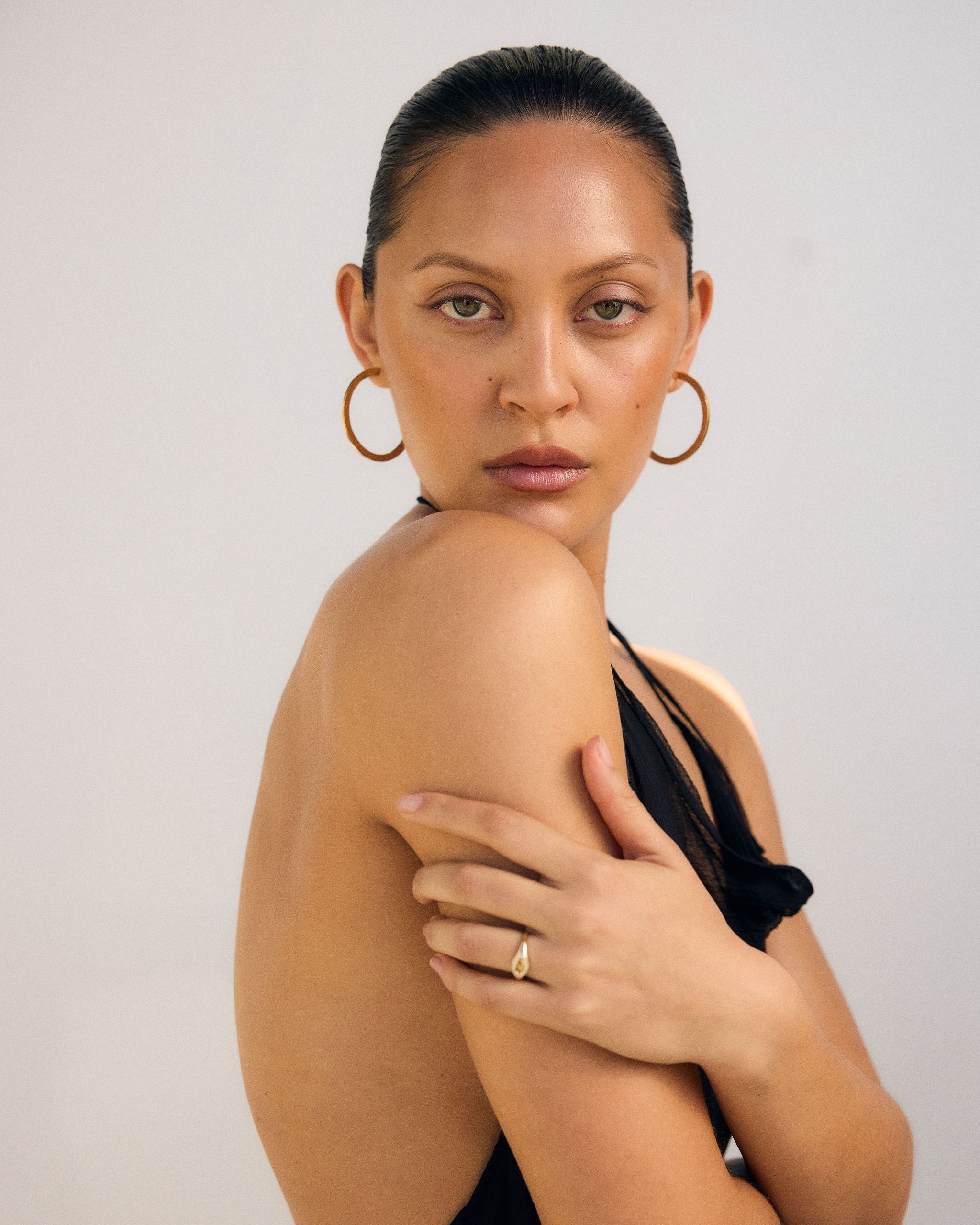 Woman wearing a black dress with a plain background