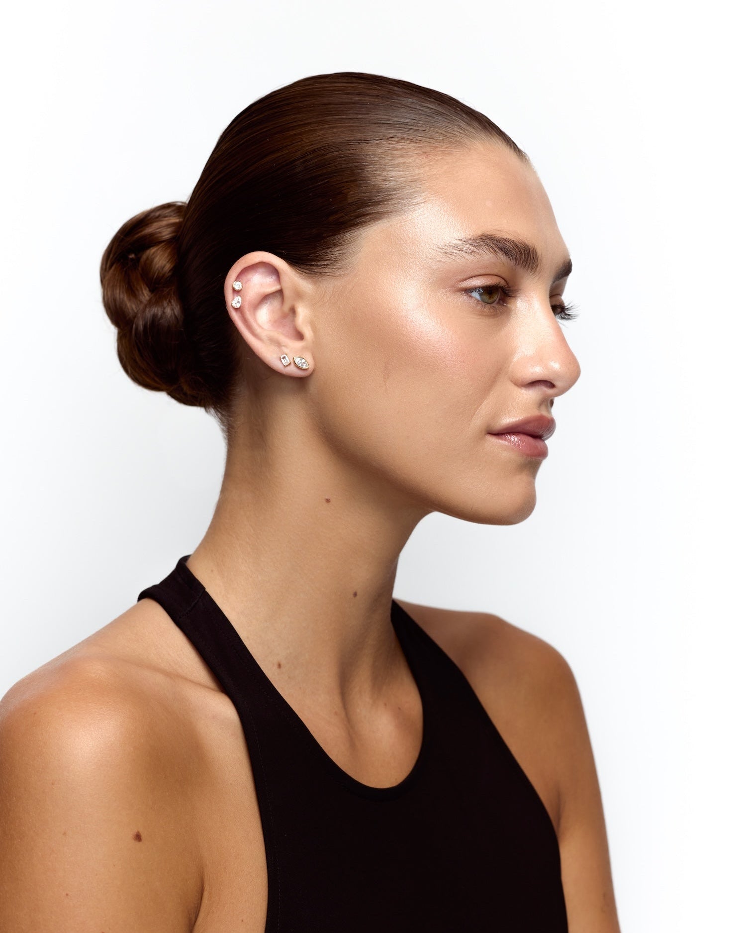 Woman wearing a black sleeveless top against a white background