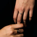 Close-up of a person's hand with a petite evil eye ring
