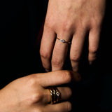 Close-up of a person's hand with a petite evil eye ring