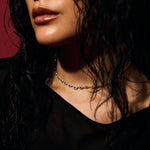 Close-up of a person with wet hair against wearing pave evil eye tennis necklace