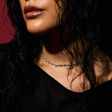 Close-up of a person with wet hair against wearing pave evil eye tennis necklace