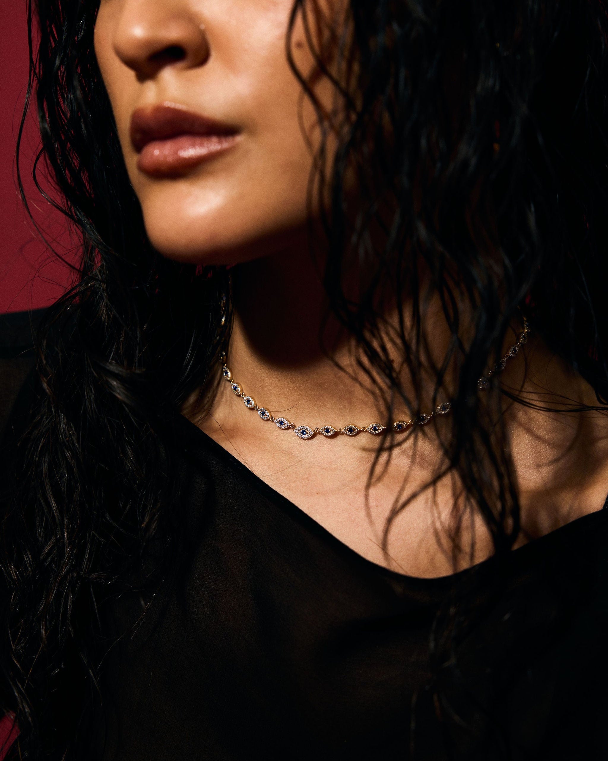 Close-up of a person with wet hair against wearing pave evil eye tennis necklace