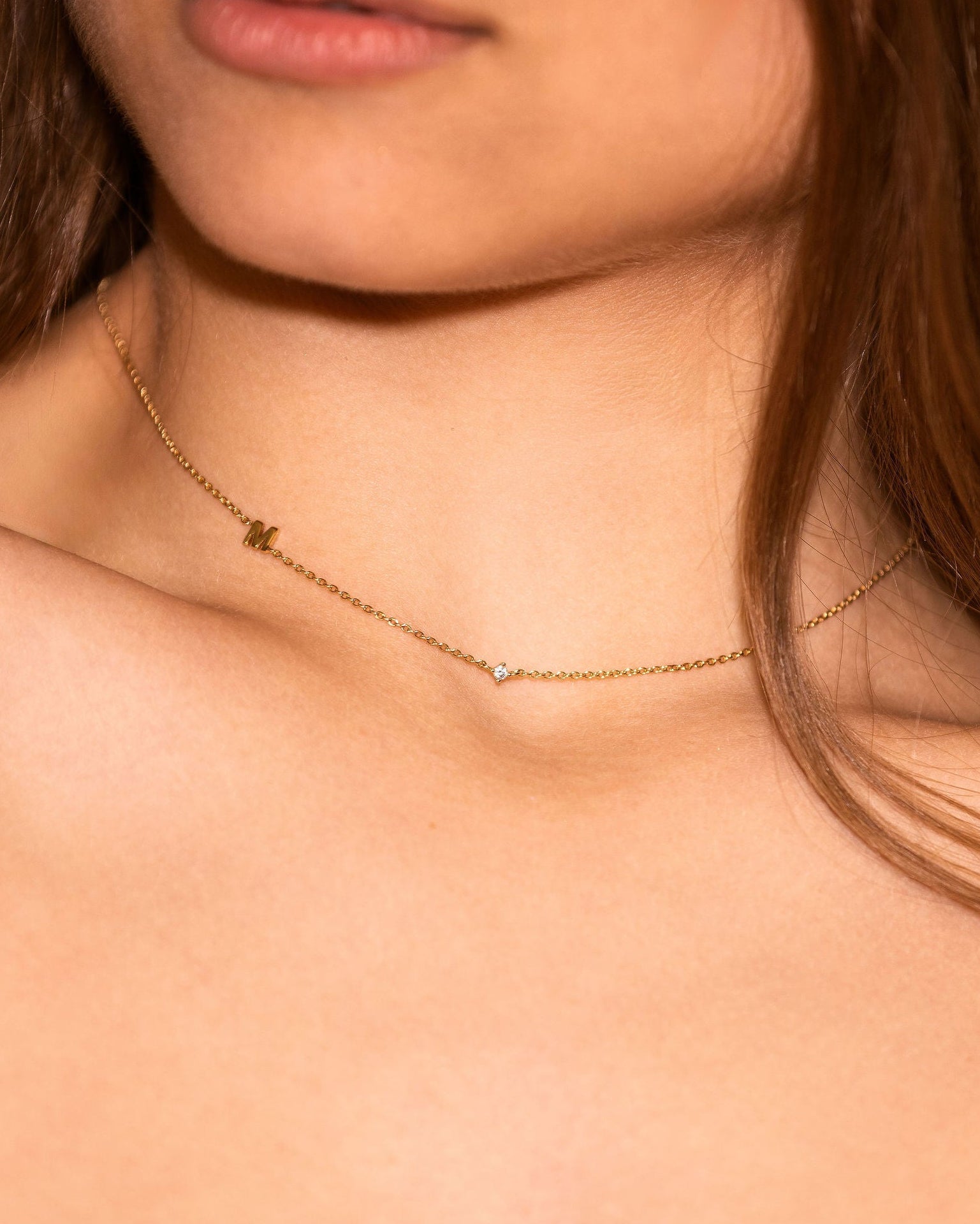 Neckline of woman with fine gold necklace