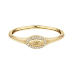 Gold ring with a central engraved design on a white background