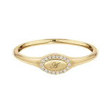 Gold ring with a central engraved design on a white background