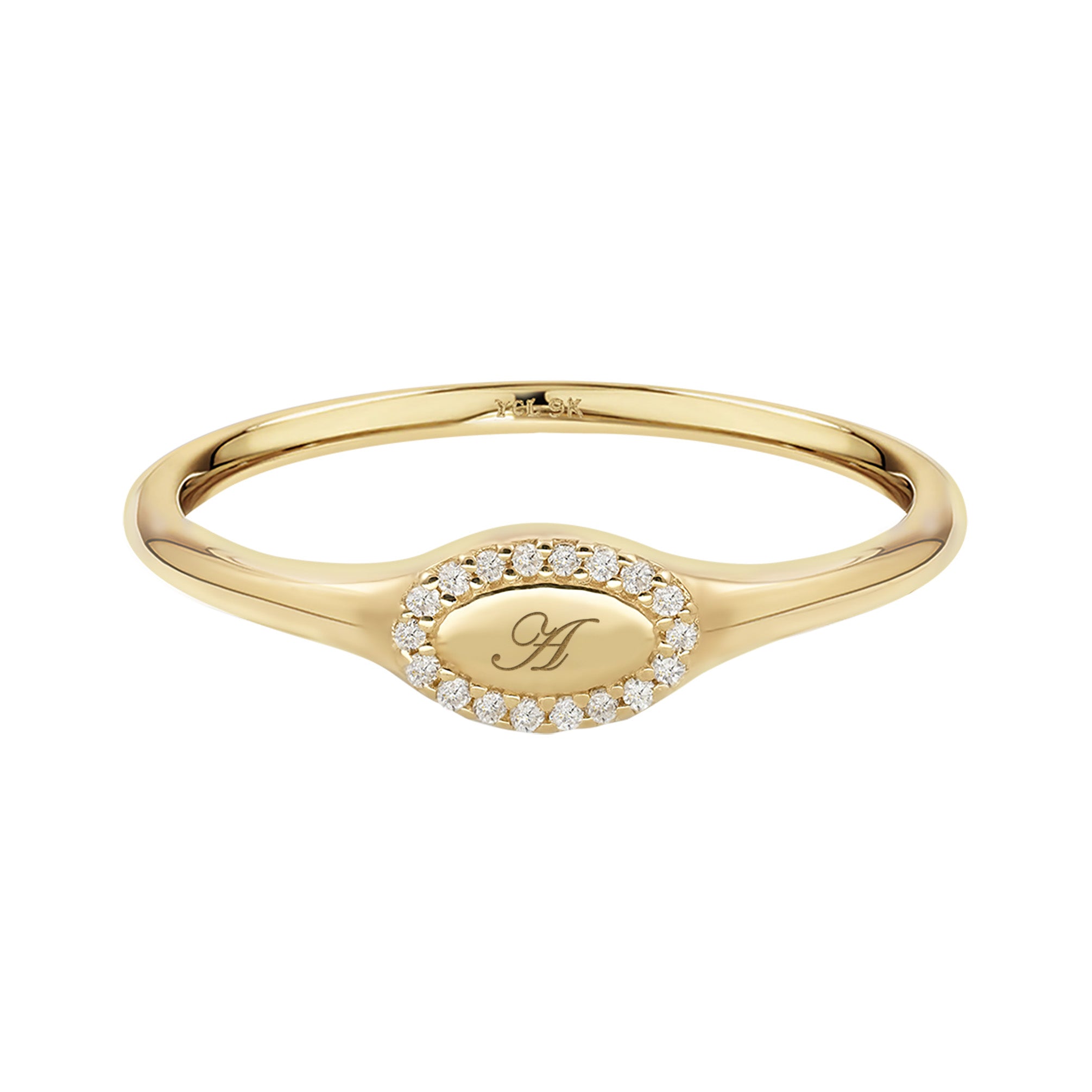 Gold ring with a central engraved design on a white background