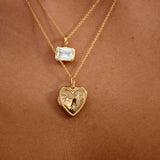 Gold necklaces with heart-shaped and star pendants on a skin background